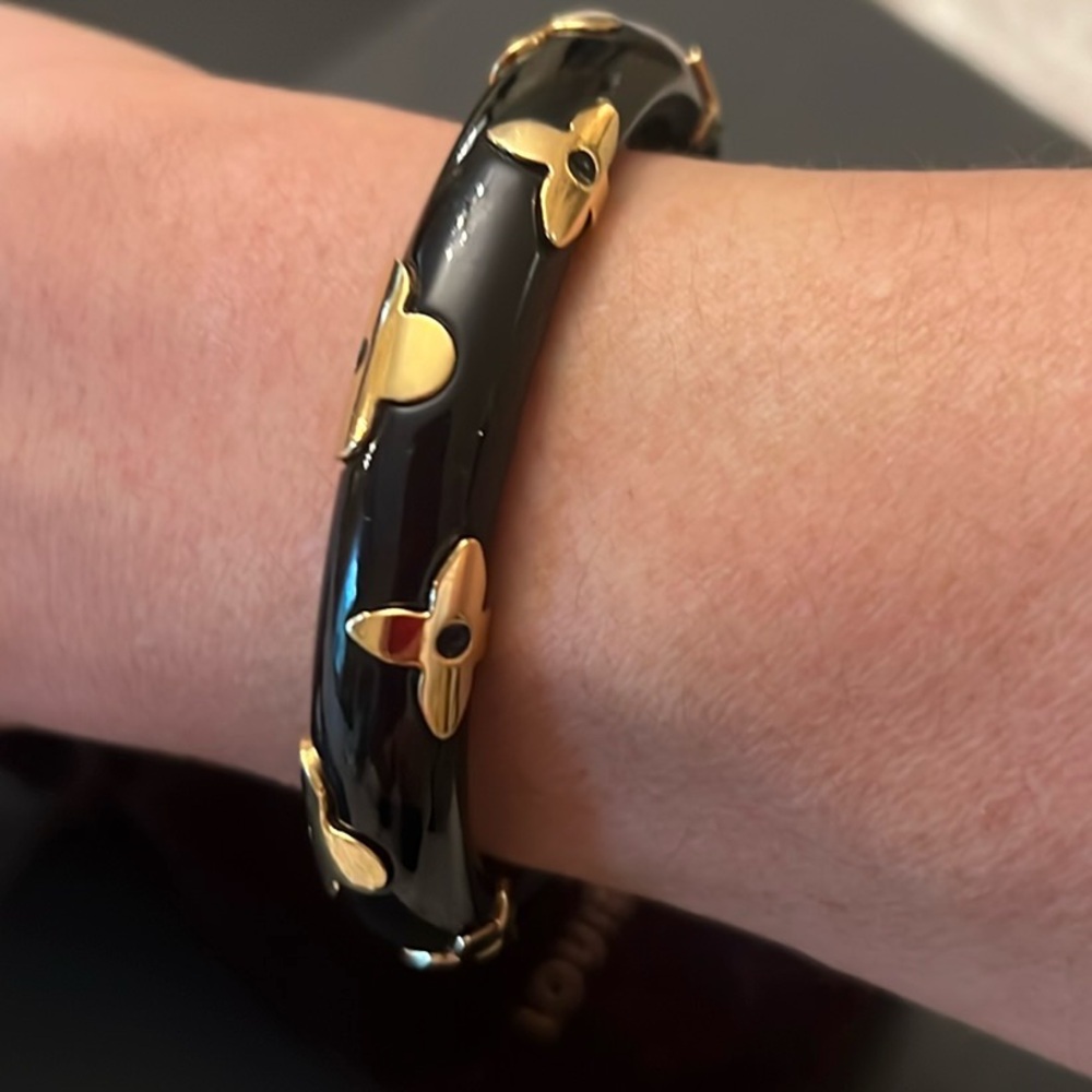 Authentic Louis Vuitton black  thin cuff bracelet with gold tone logo